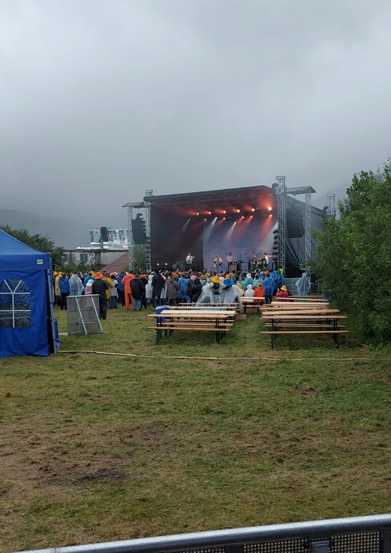 Oversiktsbilde av Høllafestivalen 2022 hvor været ikke var så bra. Brenn. spiller på hovedscenen.